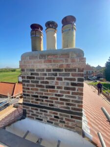 Rebuilt brick chimney stack with chimney pots in Fulford, York