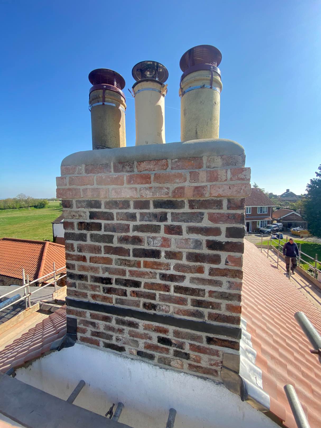 Rebuilt brick chimney stack with chimney pots in Fulford, York